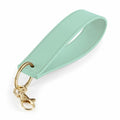 The Bagbase BG747 key ring is designed with a mint green leather loop and features a gold-toned clasp and ring for attaching keys.