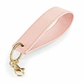 Introducing the BG747 by Bagbase: a pink textured leather keychain wrist strap featuring a gold metal clasp and keyring. The looped design ensures easy wearing and convenience.