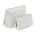 The Bagbase BG751 collection includes two white cosmetic bags of varying sizes. These stylish bags boast a textured surface and sleek design, complemented by elegant gold-toned zipper pulls. They are arranged side by side, with the larger bag positioned just behind the smaller one.