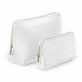 Two Bagbase BG751 toiletry bags in different sizes, featuring gold-colored zippers and crafted from a smooth material, are arranged side by side against a plain white background.