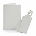 The BG755 set from Bagbase includes a light gray, textured passport holder and a matching luggage tag with a gold-tone buckle. Both items are crafted from sleek material and displayed against a white background.