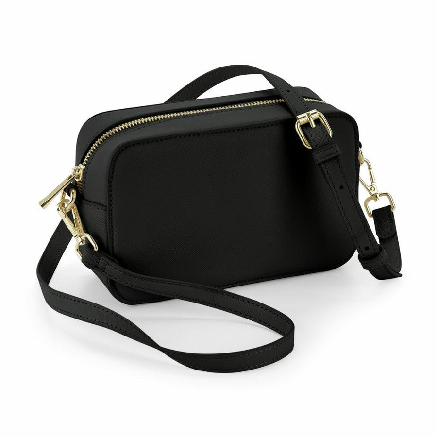 A Bagbase BG758, a black rectangular handbag featuring a detachable strap and gold zippers.