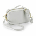 The Bagbase BG758 is a light grey rectangular crossbody bag with a top zipper and an adjustable strap, featuring gold metal hardware.