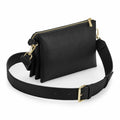 Introducing the Bagbase BG759: A black leather crossbody bag adorned with gold hardware, complete with a wide adjustable strap and a secure zippered closure.