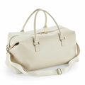 The BG760 by Bagbase is a spacious cream-colored leather duffel bag, featuring dual handles and an adjustable shoulder strap, set against a white background.
