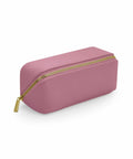 The BG761 by Bagbase is a pink rectangular pencil case featuring a gold zipper and a glossy finish.