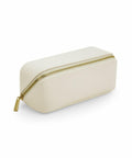 The BG761 by Bagbase is a white rectangular pouch featuring a gold zipper. It stands upright on a light surface, highlighting its simple and elegant design.