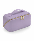 The Bagbase BG762 is a sleek, minimalist rectangular lavender cosmetic bag with a smooth texture and a convenient handle on top. It features a gold zipper with two pulls for easy access.
