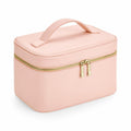 The Bagbase BG763 is a light pink rectangular cosmetic bag featuring a top handle and a gold zipper encircling the middle. It boasts a structured shape with a soft texture.