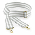 Introducing the Bagbase BG765, featuring a stylish striped fabric bag strap with gold hardware and adjustable buckles, designed with elegant gray and white horizontal stripes.