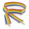 The Bagbase BG765 is an adjustable bag strap with gold buckles, featuring horizontal bands in vibrant shades of purple, pink, yellow, green, and blue.