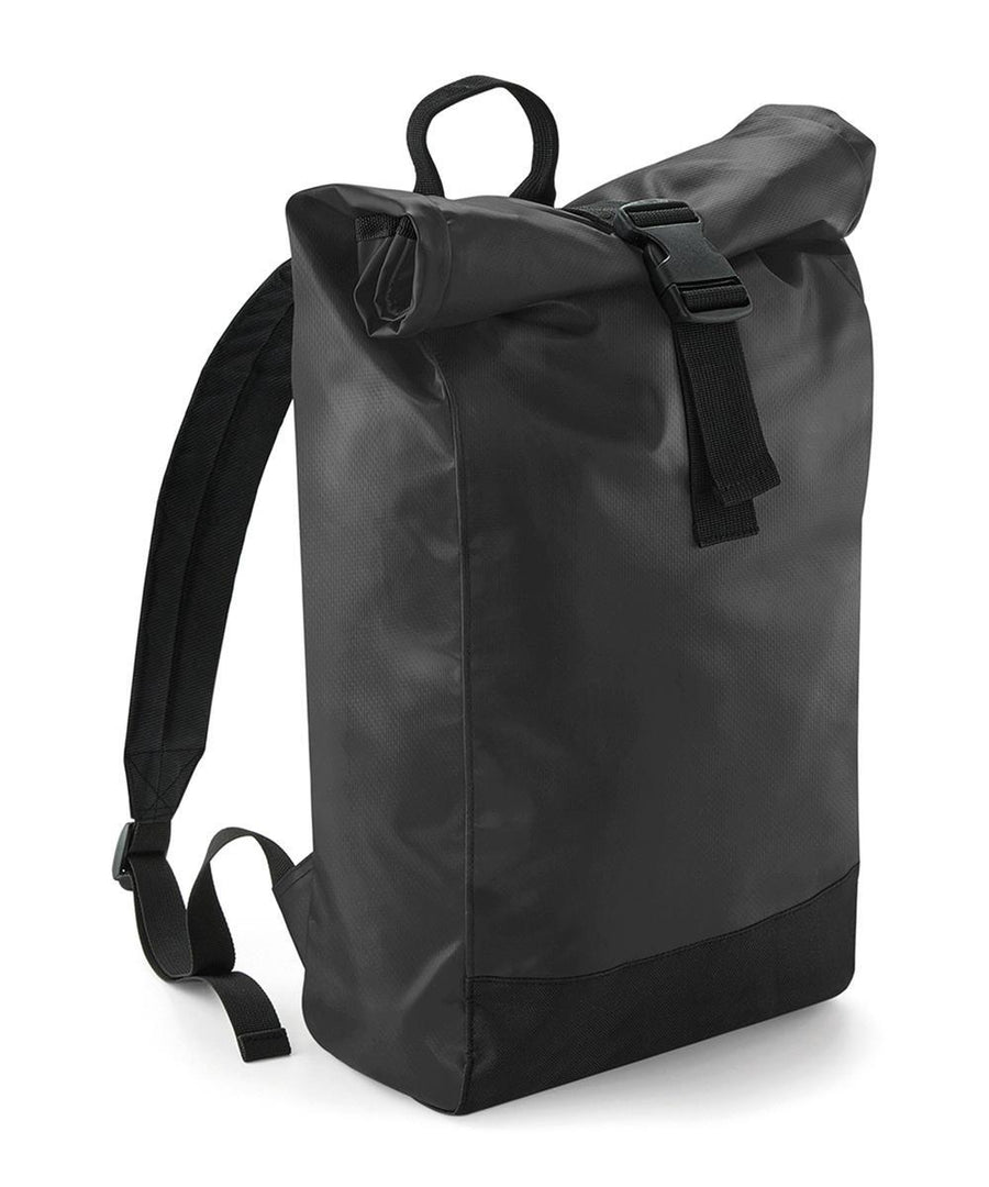 The Bagbase Tarp roll-top rucksack features a plain black design with adjustable shoulder straps, a top handle, and a black buckle fastening on the rolled flap, shown against a white background.