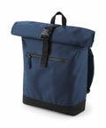 The Bagbase BG855 is a blue backpack featuring a roll-top closure, a front zipper pocket, and a black strap.