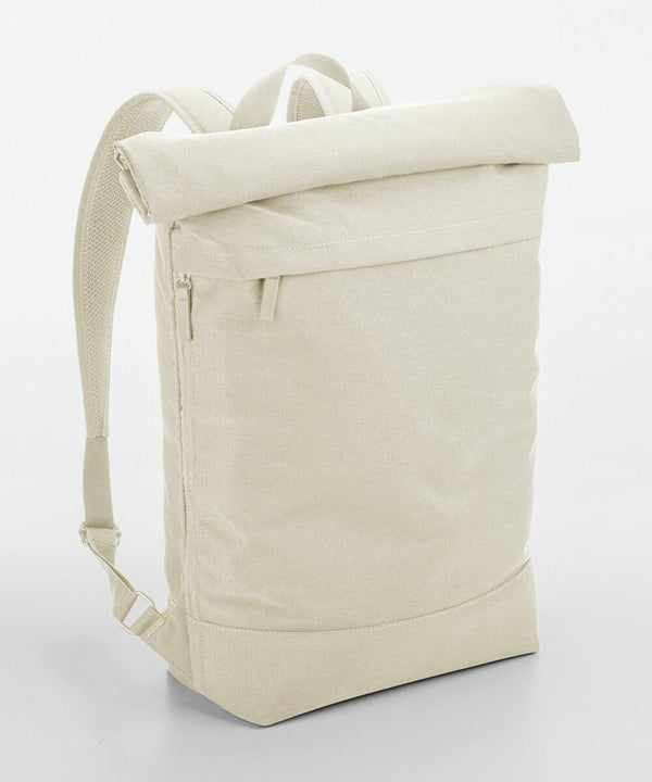 A minimalist, cream-colored backpack with a roll-top closure. It features a front zipper pocket and adjustable shoulder straps. The design is sleek and simple, giving a modern, utilitarian appearance. The background is plain white, emphasizing the BG870 from Bagbase's details.