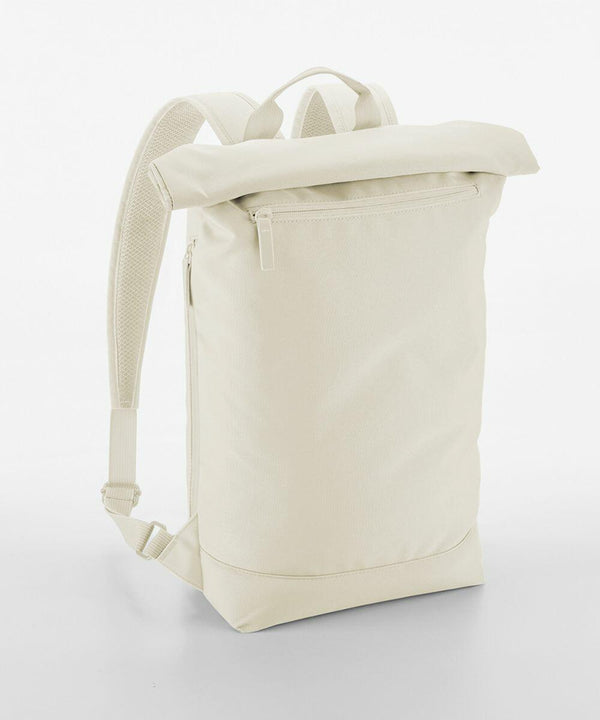 A minimalist beige backpack with a roll-top design, a front zippered pocket, and padded shoulder straps. The material has a smooth, clean finish. The Bagbase BG871 is standing upright on a plain white background.