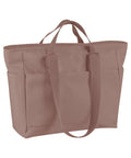 Bags is a light mauve canvas tote featuring two short handles, two long shoulder straps, two external side pockets, and a simple rectangular shape.
