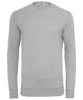 The "BY010" sweater by Build Your Brand is a plain gray long-sleeve design with a crew neck, ribbed cuffs, and hem, showcased on a white background.