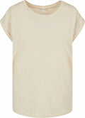 A plain, light beige T-shirt by Build Your Brand, labeled as BY021, featuring short rolled-up sleeves. The shirt boasts a simple round neckline and a casual, relaxed fit, set against a white background.