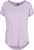 The BY036 by Build Your Brand is a lavender t-shirt featuring short sleeves and a round neckline, set against a white background. The shirt is made from soft, lightweight fabric and includes a slightly curved hem.