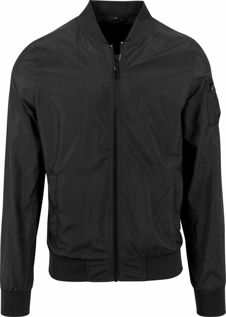 The BY045 jacket from Build Your Brand is a black bomber featuring a front zipper, a pocket on the sleeve, and ribbed detailing on the collar, cuffs, and hem.