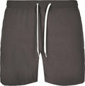 The BY050 shorts by Build Your Brand feature a front view showcasing their dark gray color with white drawstrings. They are designed with an elastic waistband, presenting a straightforward and casual style ideal for both leisure and athletic activities.