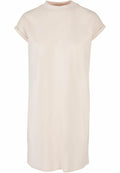 The BY101 dress by Build Your Brand is a simple, cream-colored, short-sleeved piece with a high neckline and a loose fit. It features rolled cuffs and a minimalist design.