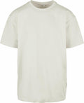 The BY102, a plain t-shirt from Build Your Brand, is displayed against a white background. This light beige shirt features short sleeves and a simple, classic crew neck style with no visible logos or designs.