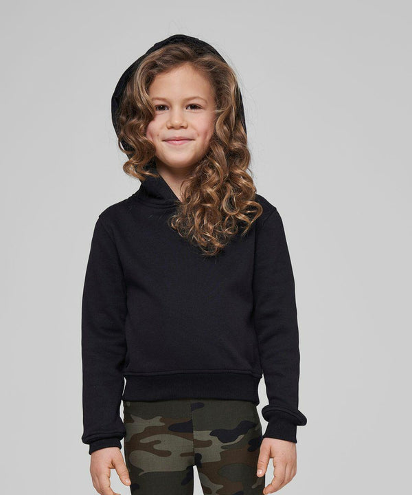 A child with curly hair stands, wearing a black BY113 hoodie by Build Your Brand and green camouflage pants, smiling against a neutral background.