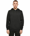 A person standing and facing forward, wearing a plain black BY137 hoodie and black pants from Build Your Brand against a white background.