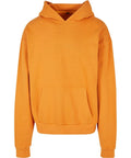 A BY162 orange hoodie by Build Your Brand features a front pocket and hood. It is laid flat, highlighting its long sleeves and minimalist design.