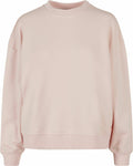 A long-sleeved, light pink crew neck sweatshirt from Build Your Brand's BY212 product line. It features a soft fabric and a slightly oversized design for a comfortable and relaxed fit, with no visible logos or patterns.