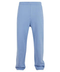 Trackwear light blue joggers with elasticated waistband and straight legs, featuring a pocketless, drawcord-free design. Shown against a plain white background.