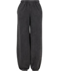 A pair of black tracksuit bottoms featuring a loose fit, elasticated waistband, and elasticated ankle cuffs, shown against a white background.