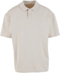 A beige, short-sleeved polo shirt with a collar and two-button placket is shown against a white background.