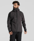 A man with a beard and wavy hair wears a Craghoppers CR700 hooded jacket, looking to the side against a plain background.