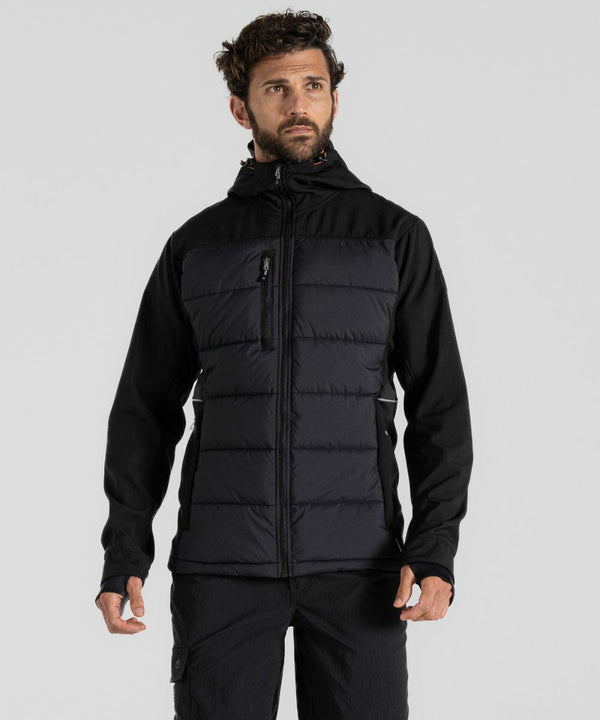 A man with short curly hair and beard, wearing a black Craghoppers CR701, looks off to the side against a plain gray background.
