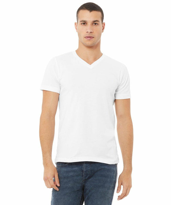 A person stands facing forward wearing a plain white Bella + Canvas CV009 V-neck t-shirt and blue jeans.