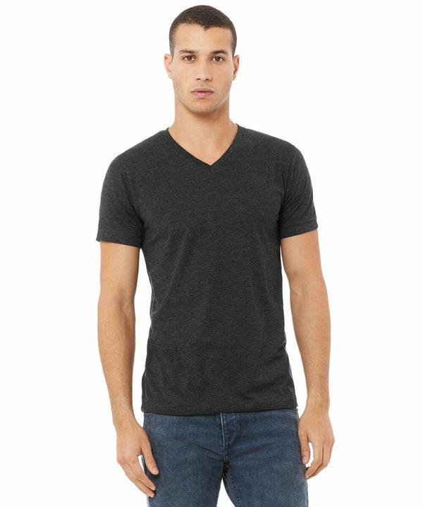 A man with short hair stands facing forward, wearing a dark gray Bella + Canvas CV09H V-neck T-shirt and blue jeans, against a plain white background.