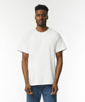 Man wearing a Gildan GD002 plain white T-shirt and blue jeans standing against a plain white background.