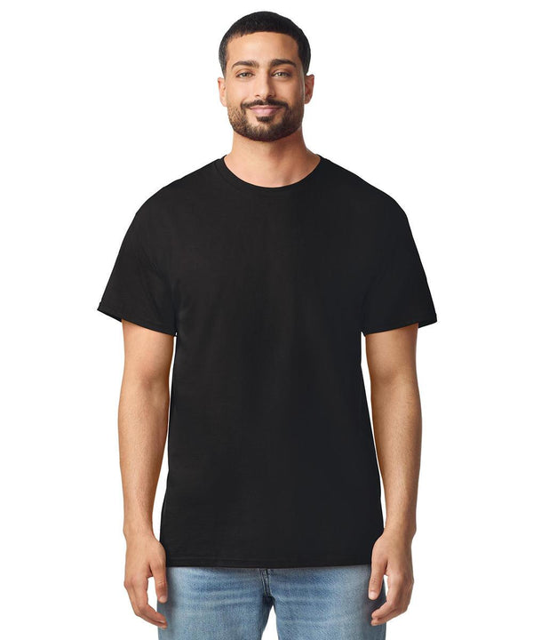 A man with short dark hair and a trimmed beard faces forward, wearing a Gildan Light Cotton adult T-shirt in black and light blue jeans, posed against a white background.