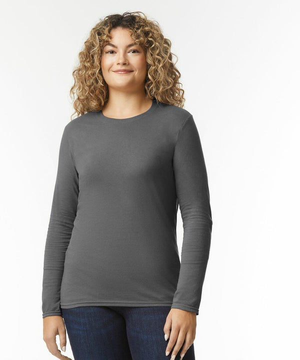 Person wearing a long-sleeve, grey GD011 by Gildan and blue jeans, standing against a plain white background.