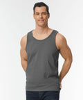 A man wearing a gray GD012 by Gildan and jeans stands against a plain white background.