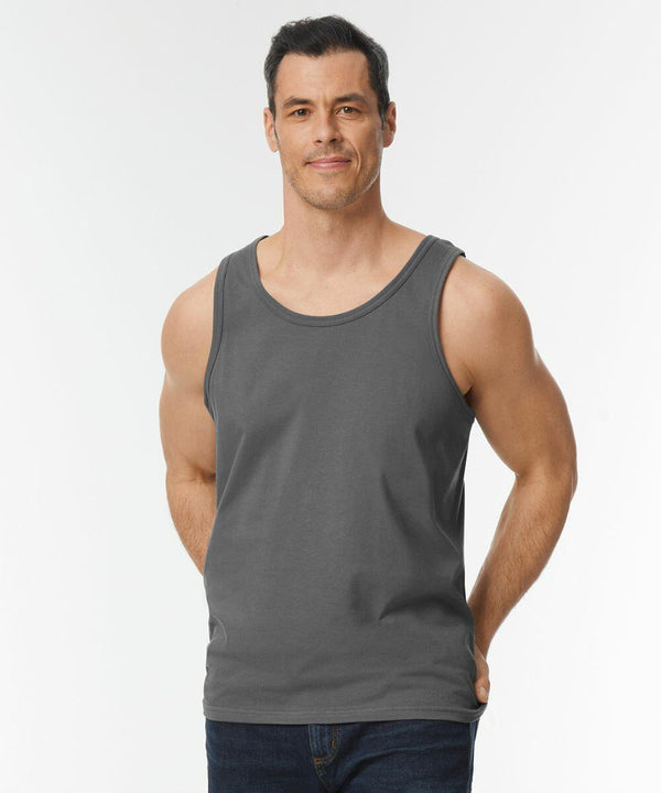 A man wearing a gray GD012 by Gildan and jeans stands against a plain white background.