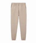 Beige tracksuit bottoms with jogger style, elastic waistband, side pockets, and elastic cuffs, shown flat on a white background.