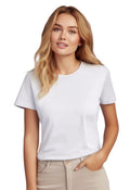 A person with long blonde hair wearing an eco-friendly white T-shirt and light-colored pants stands against a white background.