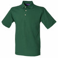 The product is the Henbury HB100, a polo shirt featuring short sleeves, a collar, and three buttons in green.