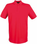 A plain red polo shirt from the Henbury brand, featuring short sleeves and a collar, displayed on a white background. The shirt includes a buttoned placket with two visible buttons. This product is identified as HB101.