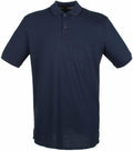 Introducing the HB101 by Henbury: A classic dark blue polo shirt featuring short sleeves, a collar, and a button-up neckline, crafted from lightweight fabric.