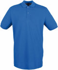 A Henbury HB101 polo shirt in plain blue, complete with short sleeves, a collar, and a three-button placket, is showcased against a white background.
