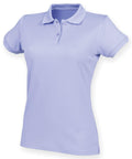 The Henbury HB476 is a women's polo shirt in light purple, featuring short sleeves, a collar, and a three-button placket. Set against a white background, it showcases its simple and classic design.